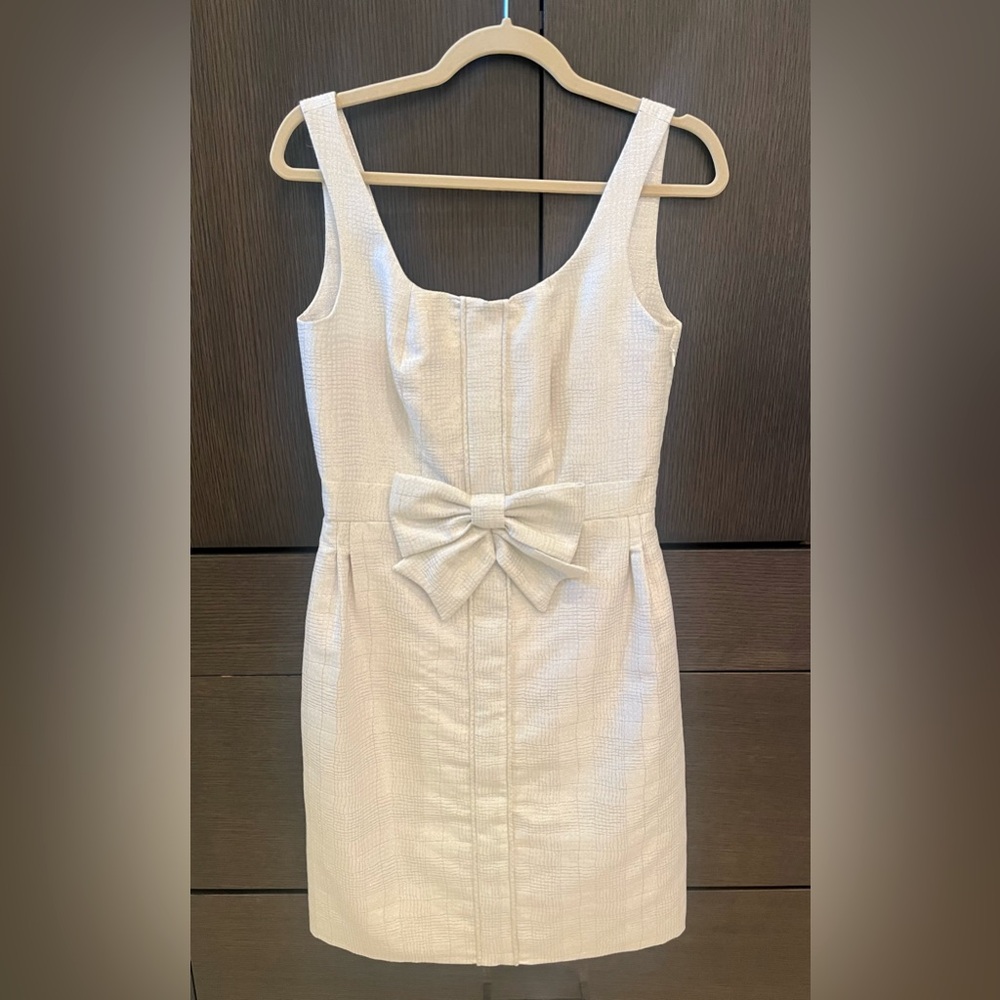 Worn twice size 6 dress by Kirribilla, cream with champagne sparkles & bow.